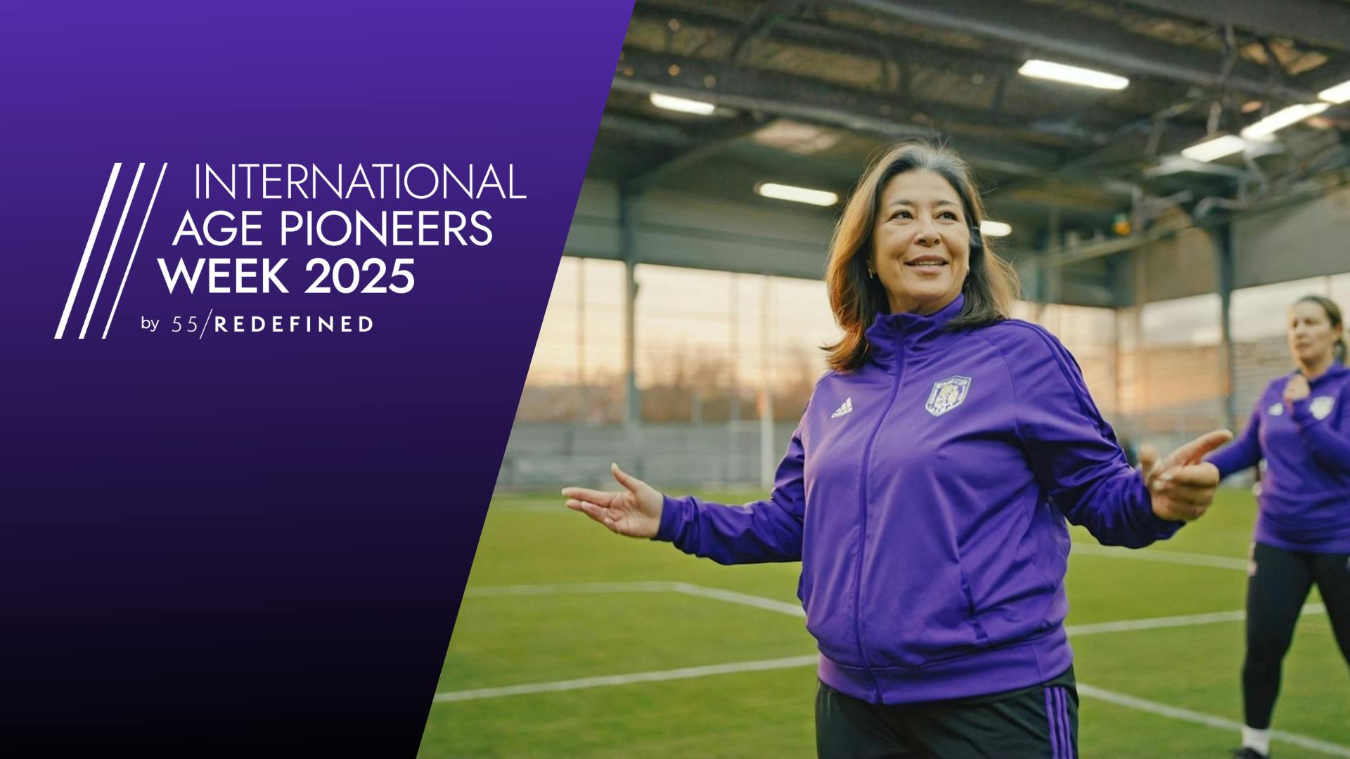 A happy midlife woman standing on a football field.