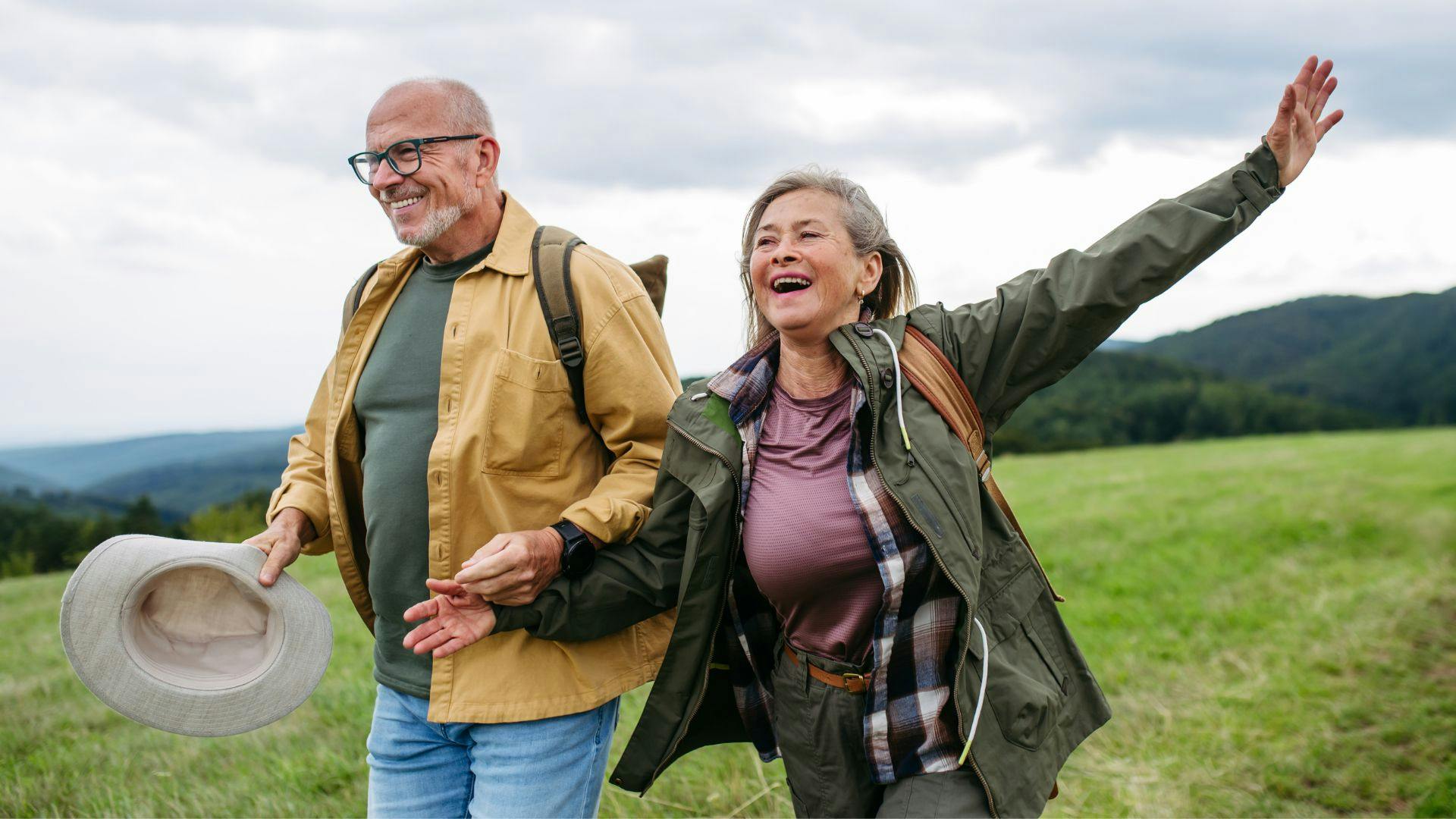 Couple on a hike, smiling and laughing
