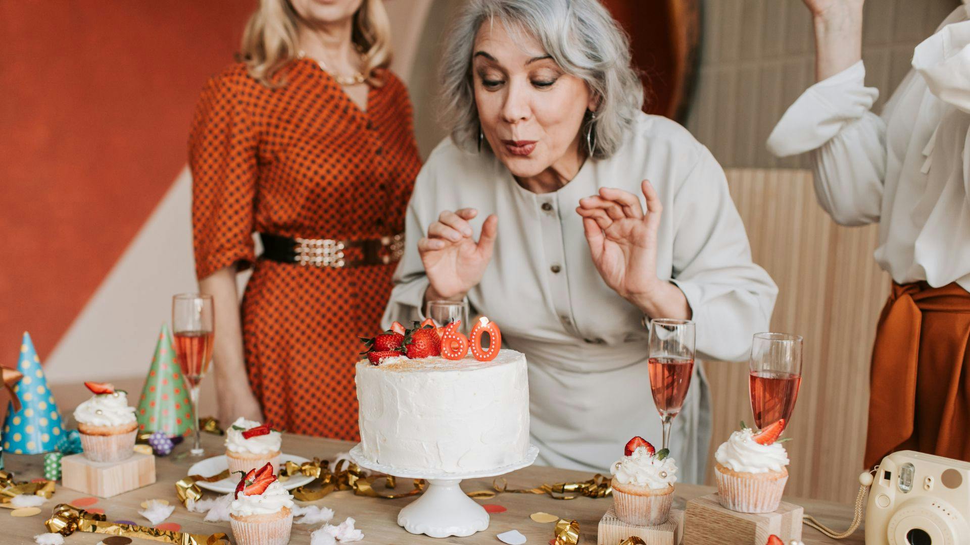 female blowing out 60th birthday candle