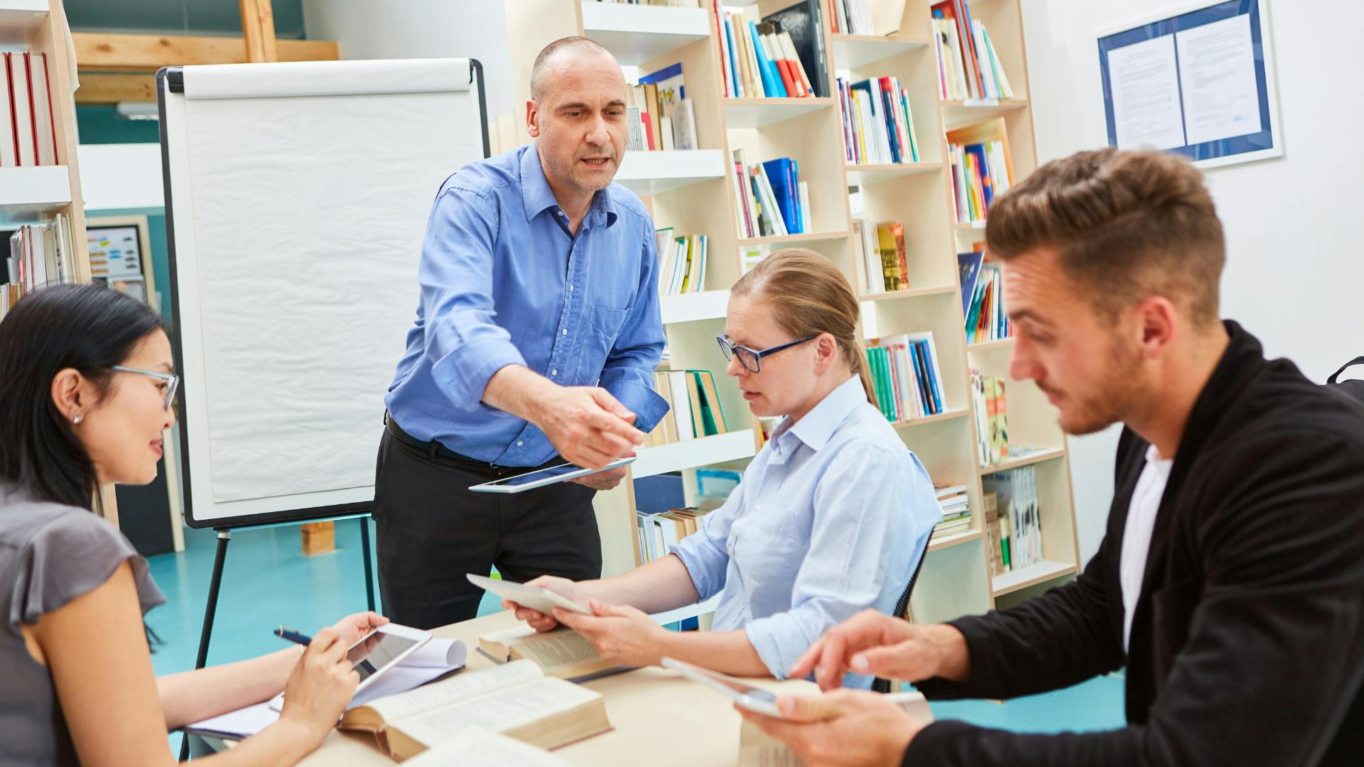 male adult education teaching small group of adults