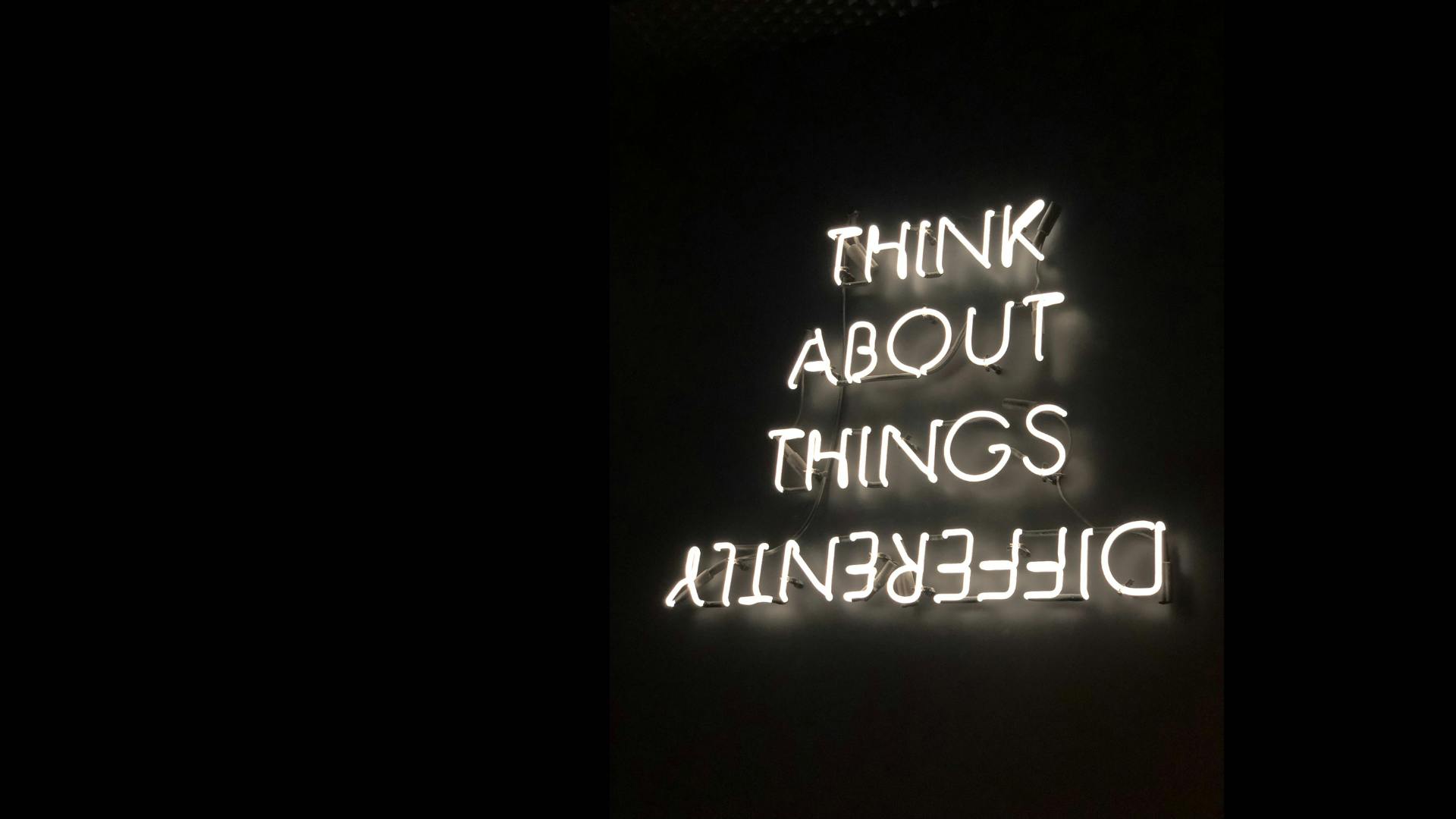 Neon sign with wording:  Think About Things Differently
