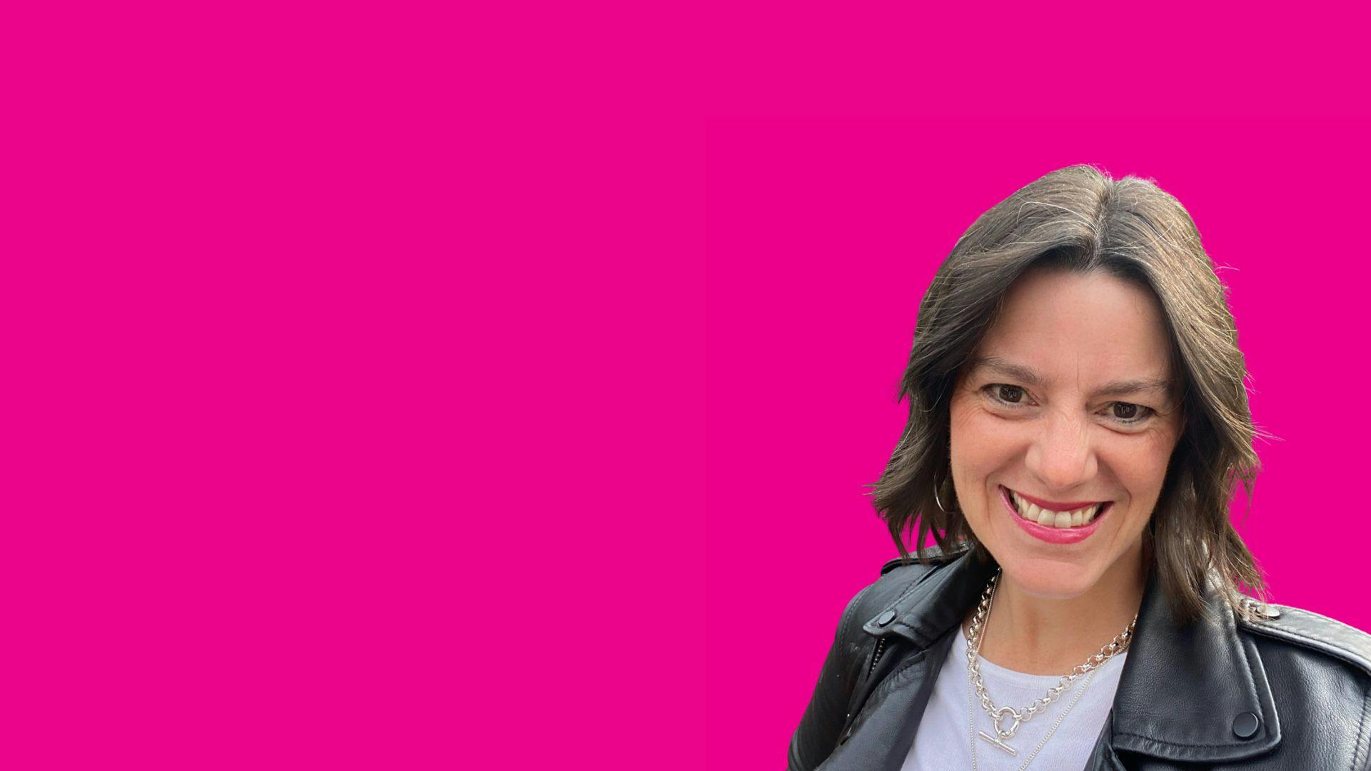 Woman in black leather jacket smiling